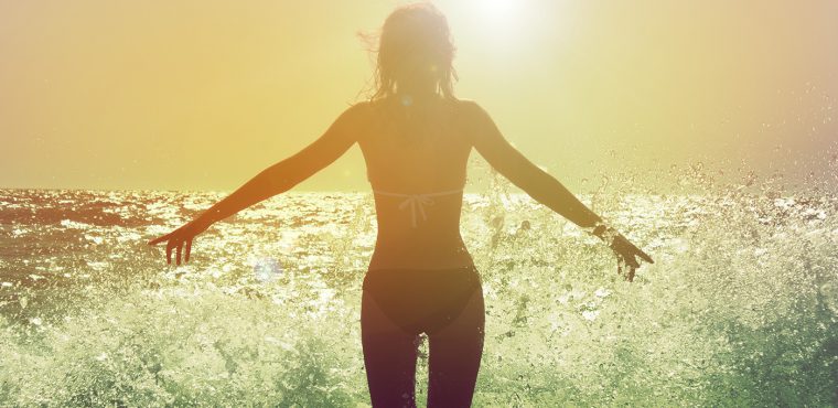 Woman at yoga retreat - at ocean